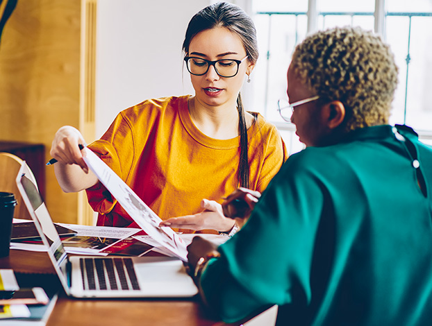 Two female marketers working on personalized campaigns.