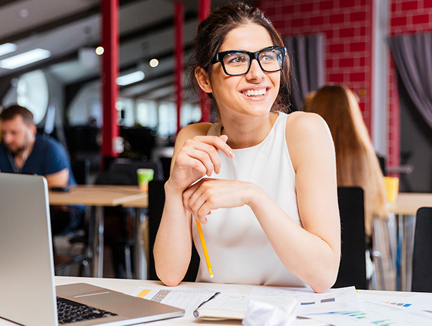 A smiling female designer working on creative strategy.