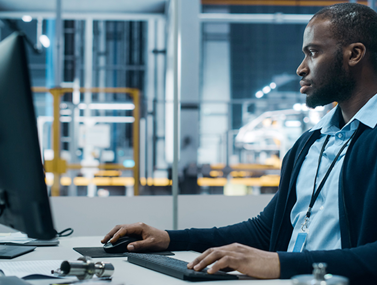 A male engineer in an energy facility looking through complince documents