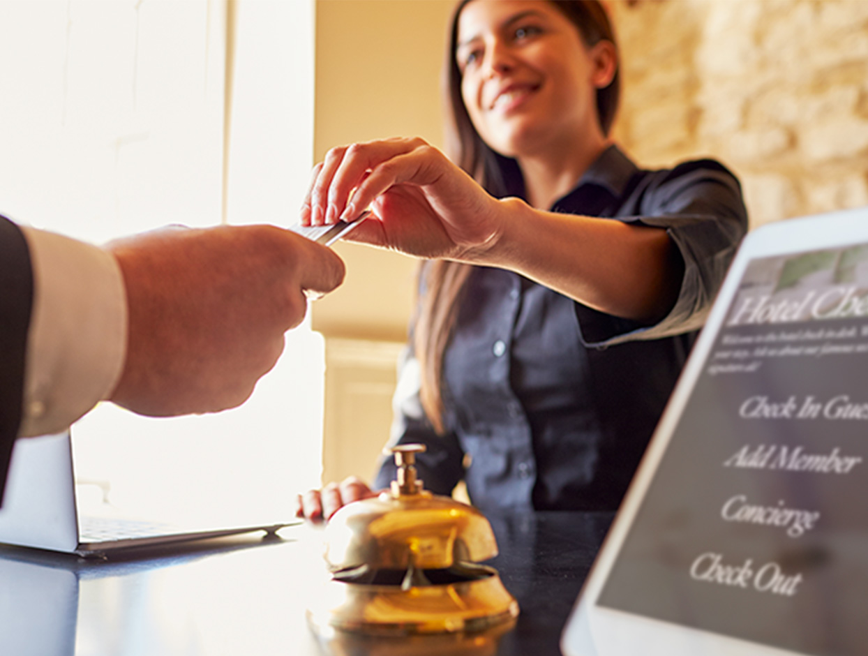Hotel receptionist hand card back to client