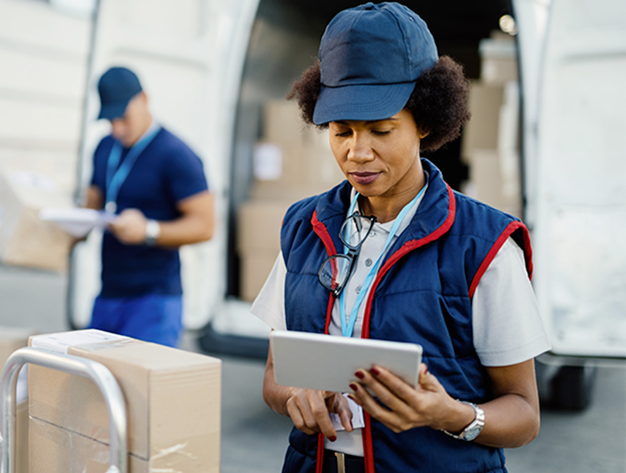 Woman delivery employee checking inventory on a tablet