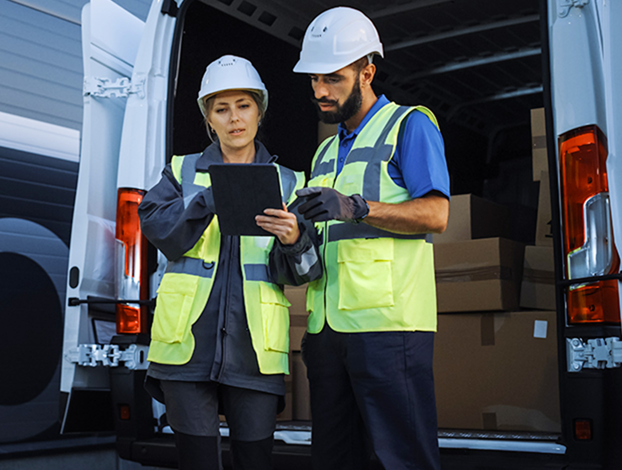 two transportation employees reviewing inventory