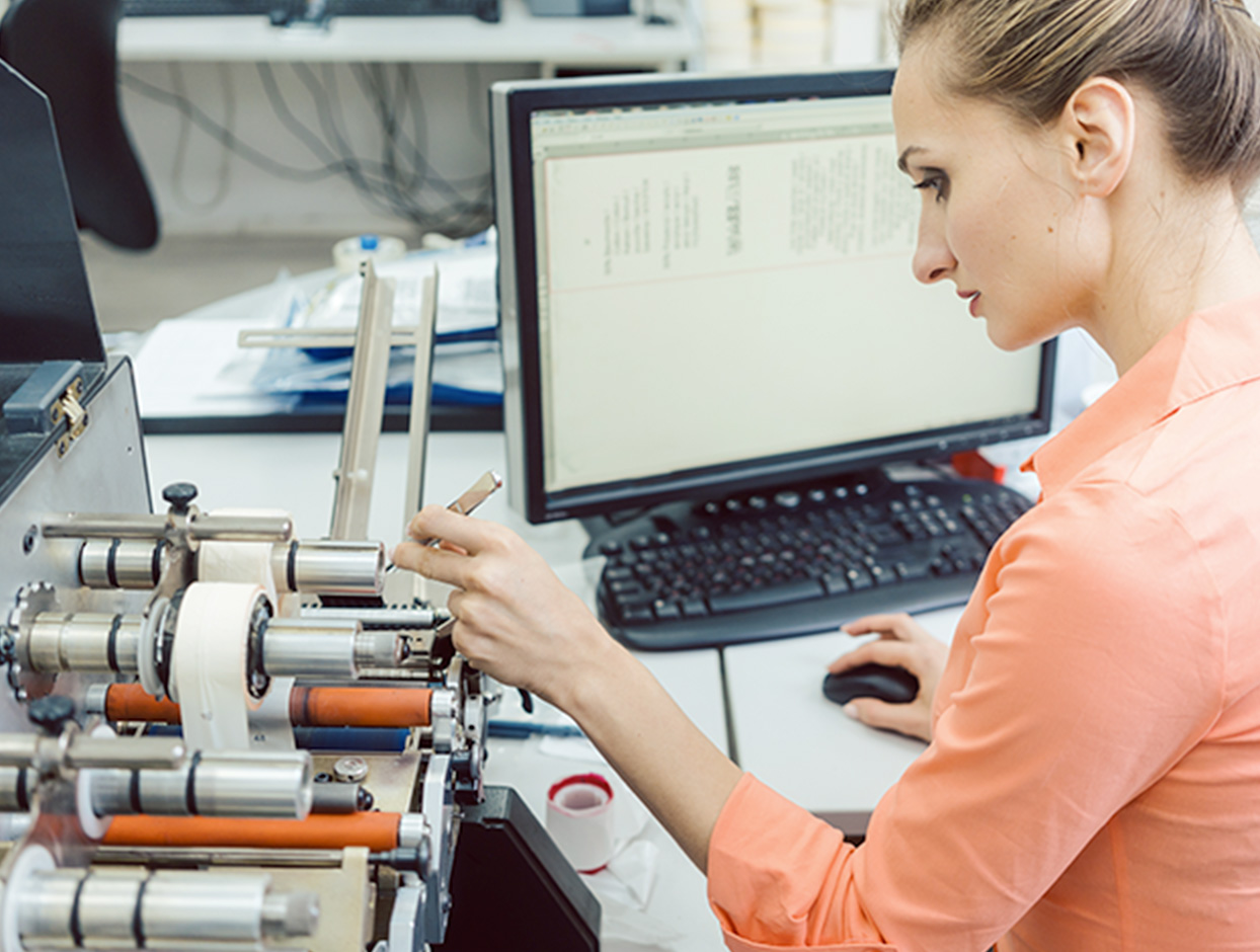 Woman technician adjusting printing labels