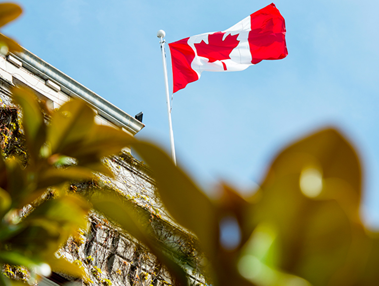 Canada flag on top an obscure building