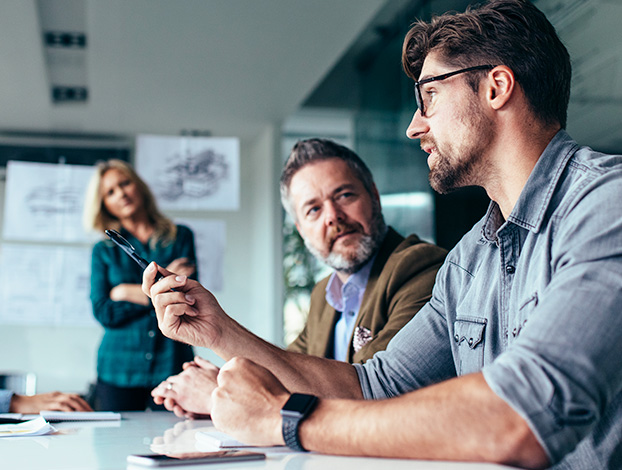 Marketers in a meeting discussing how to transform your business.