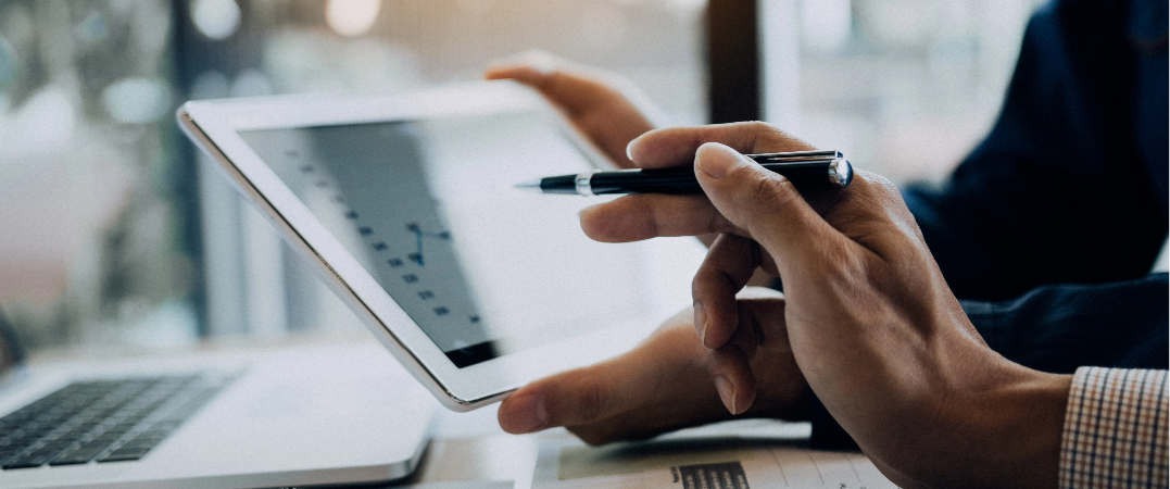 close up of hands looking at tablet overlooking strategies