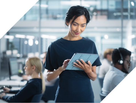 Smiling woman reviewing digital assets on a tablet.