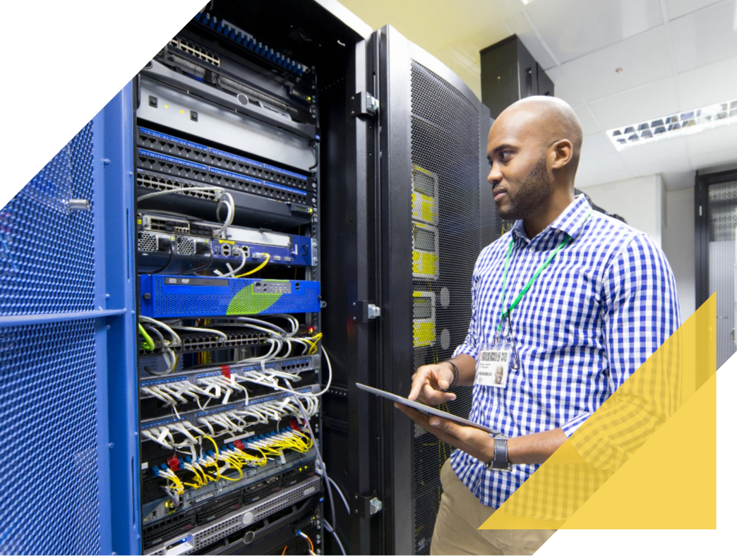 IT associate working on computer tower with a tablet