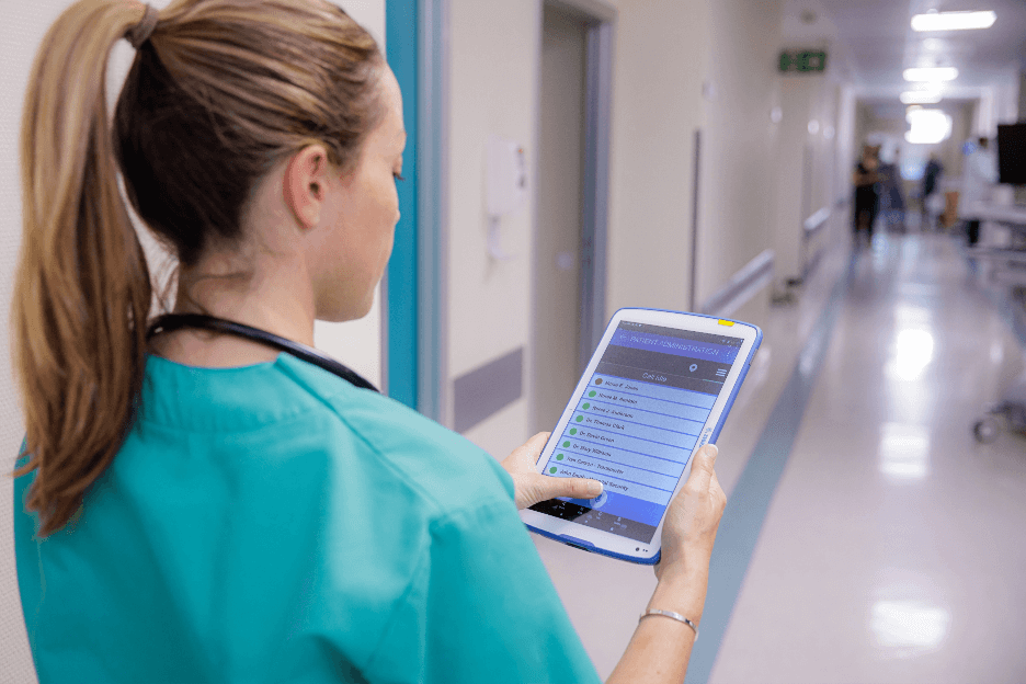 nurse at hospital review list on a tablet