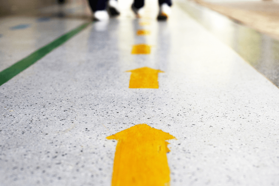 wayfinding yellow arrows on a floor