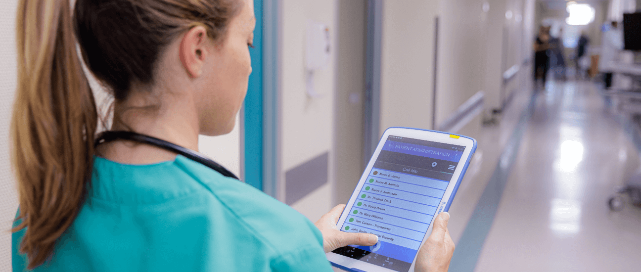 nurse at hospital review list on a tablet
