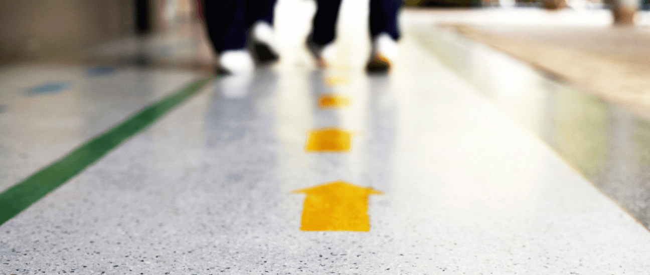 wayfinding yellow arrows on a floor