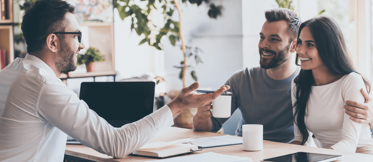 An empowered financial advisor communicating with a young couple