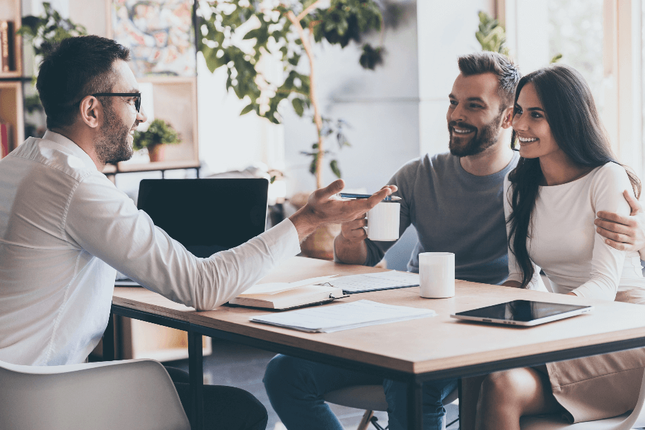 An empowered financial advisor communicating with a young couple
