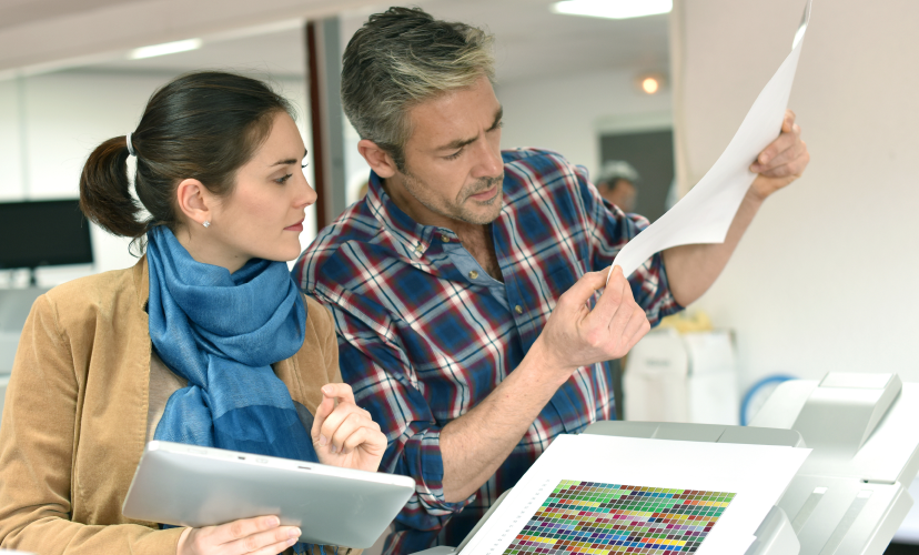 two office people review digital prints